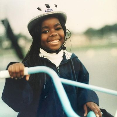 Photo of Camille Winbush's childhood riding a bicycle.